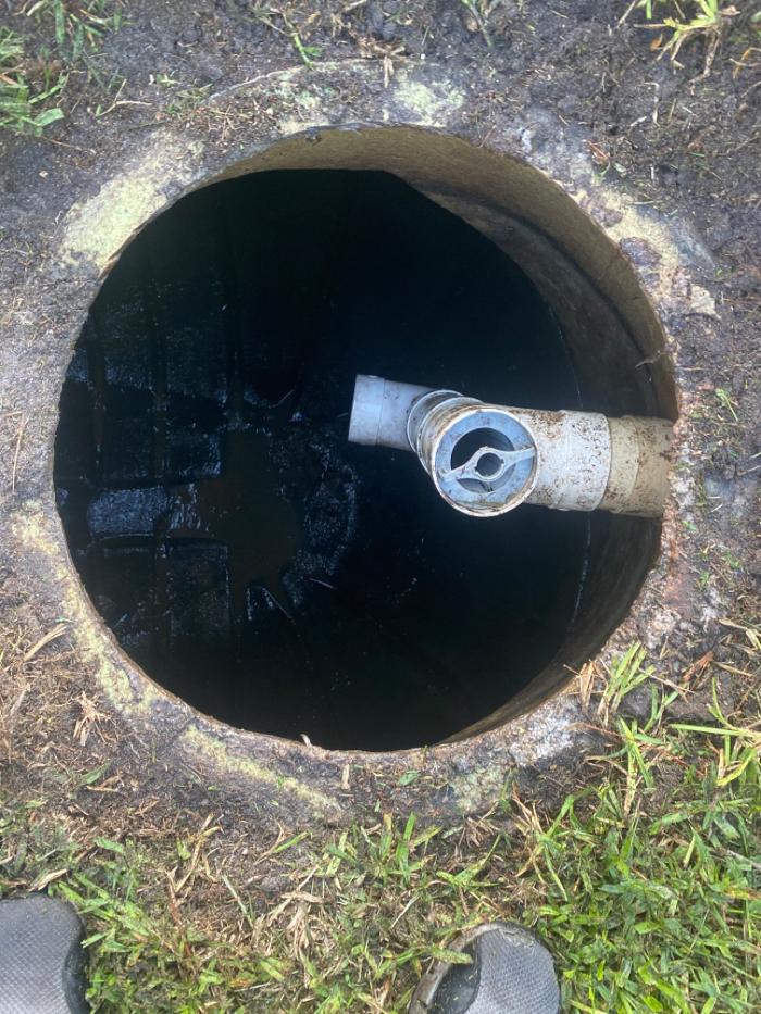 Looking down into a septic system with the cover off.