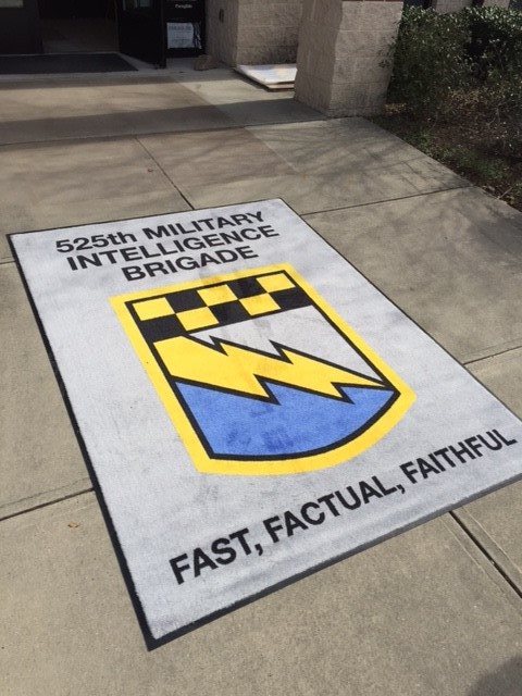 A rectangular gray rug for 525th Military Intelligence Brigade.