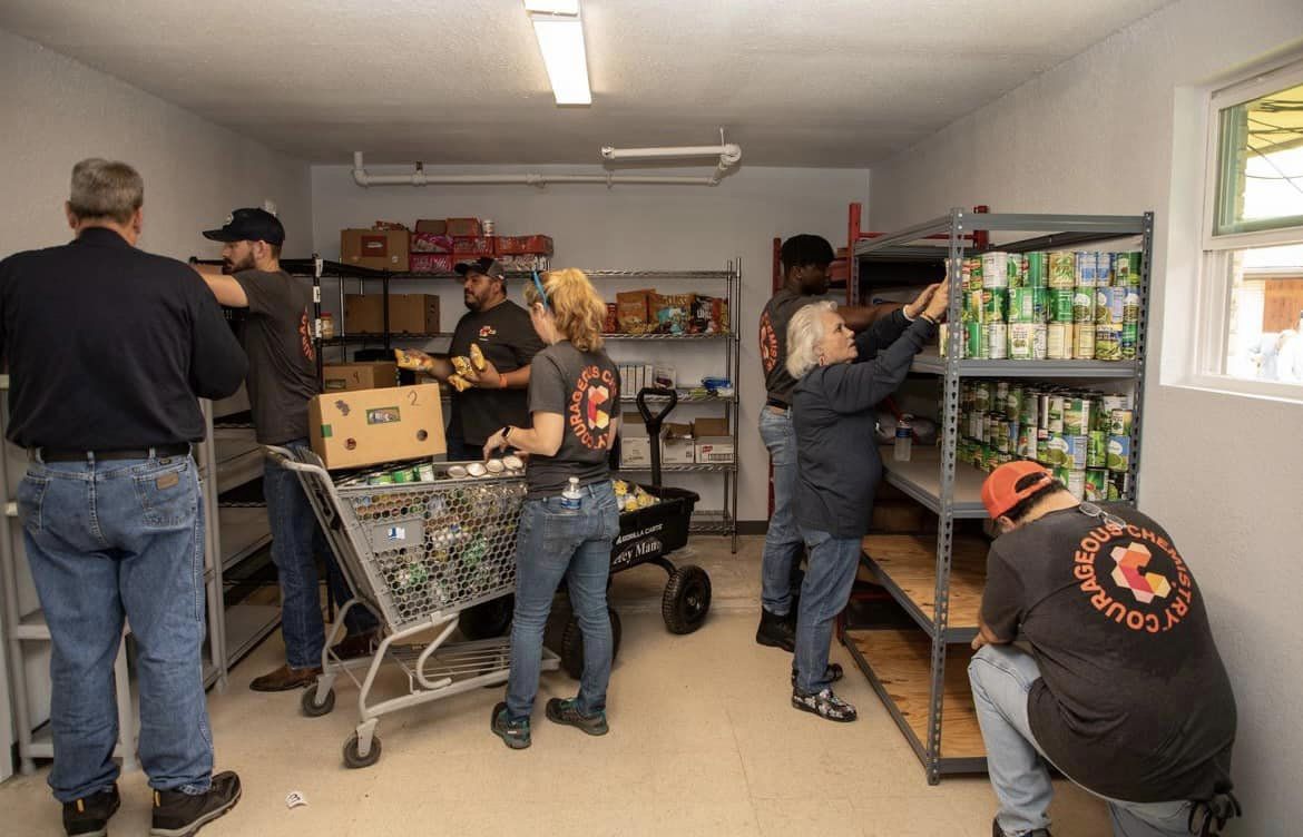 Volunteers unload non-perishable food items.