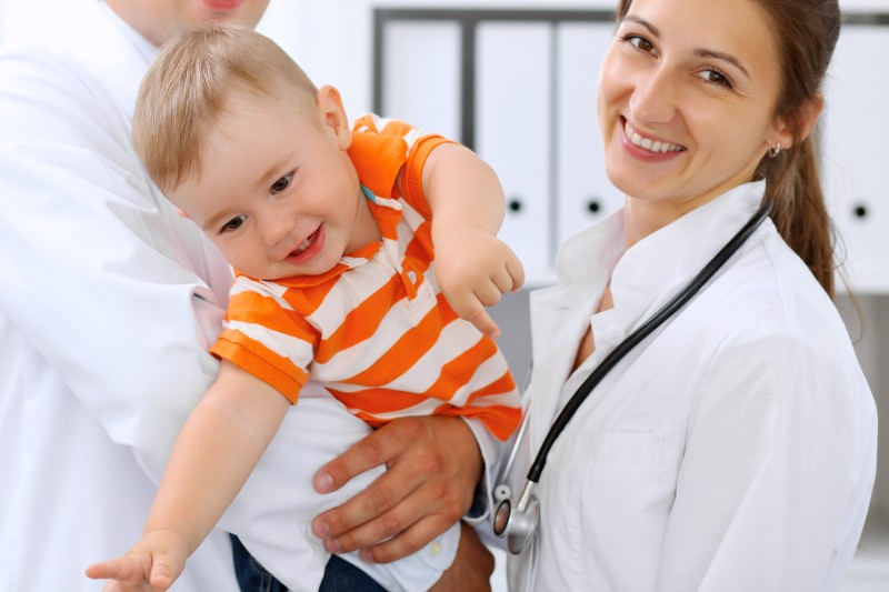 Doctors with a young boy at check up.