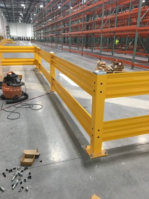 Yellow barriers keep traffic away from pallet racks.