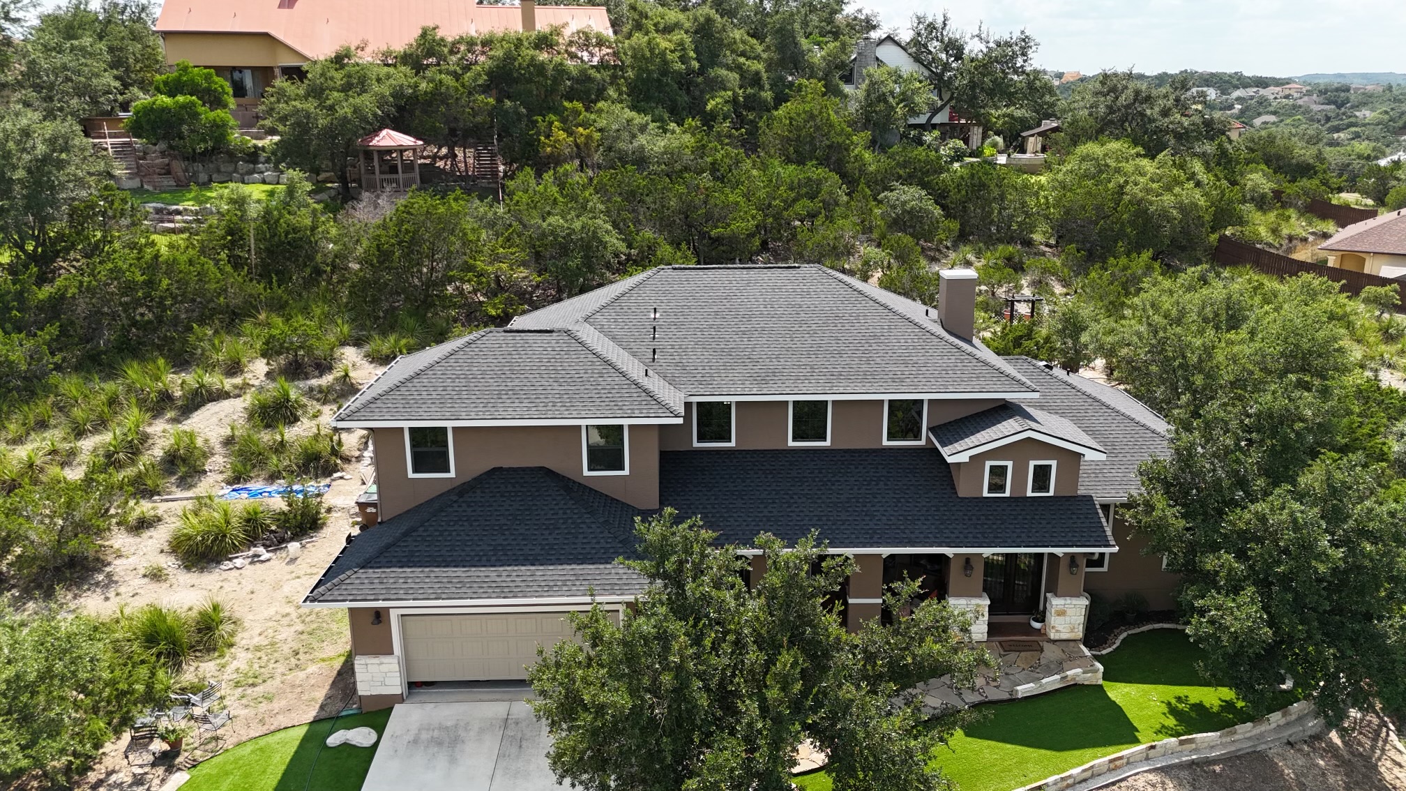 An overhead view of a large home with solar panels on the roof.