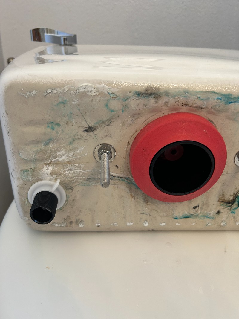 The underside of a toilet tank.