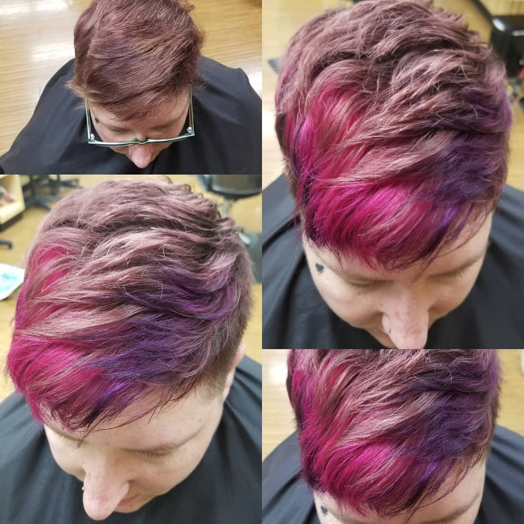 A person with short hair shows off their new style and color in pink and purple