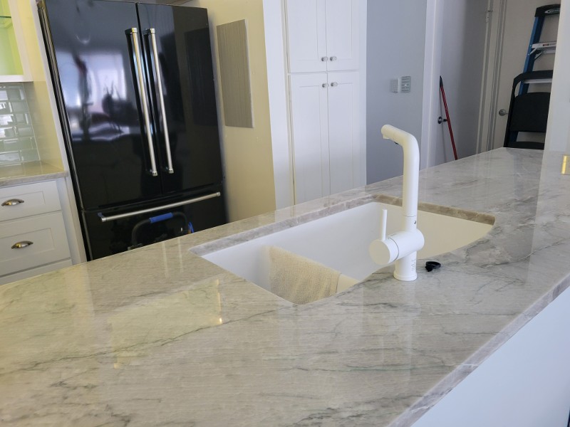 A kitchen island with a marble countertop.