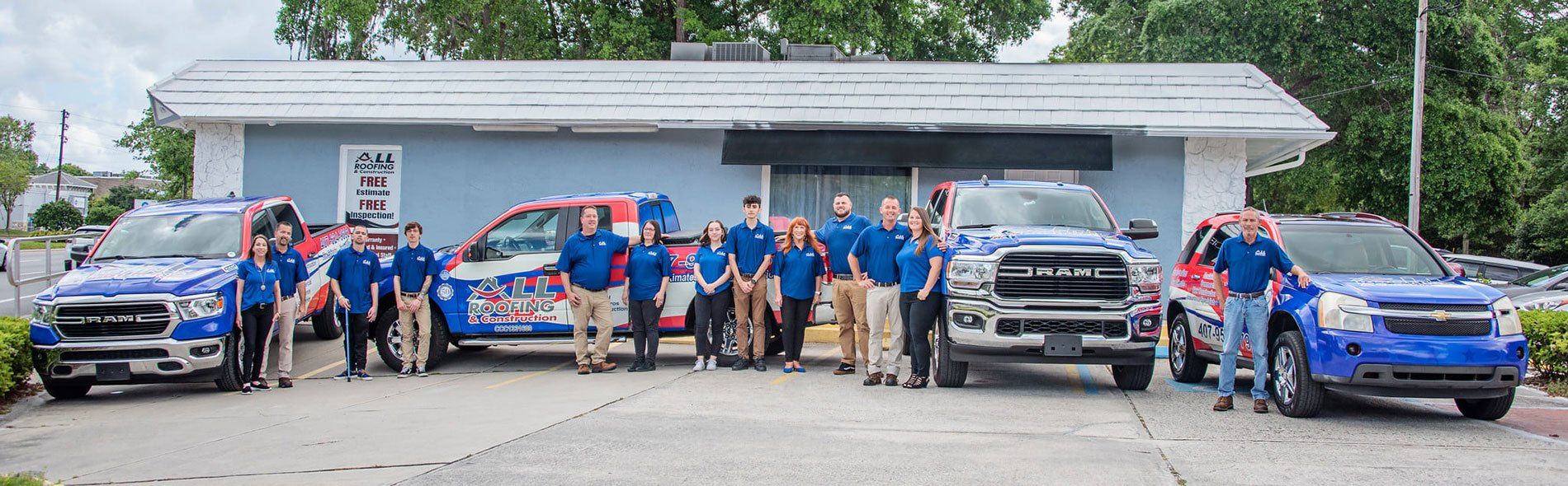 team members standing in front of business trucks