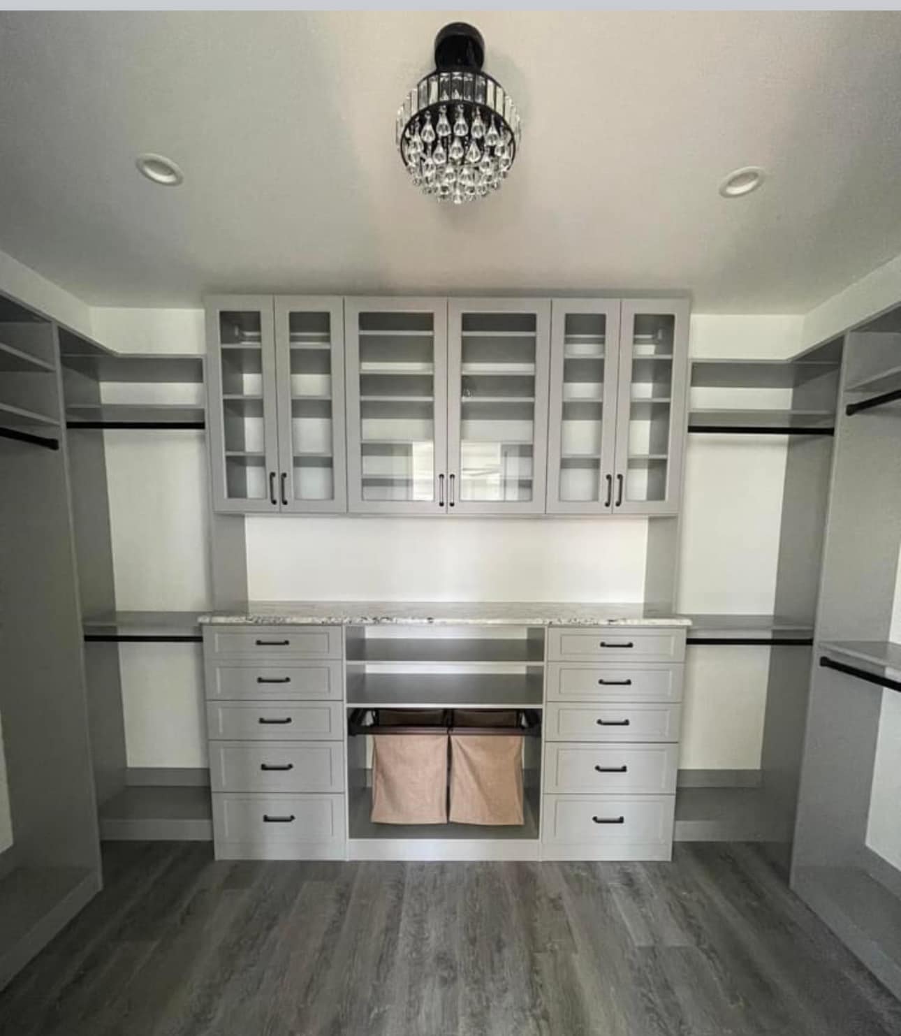 Dual-level of closet organization with a chest of parallel drawers on the bottom and glass-in shelving on top.