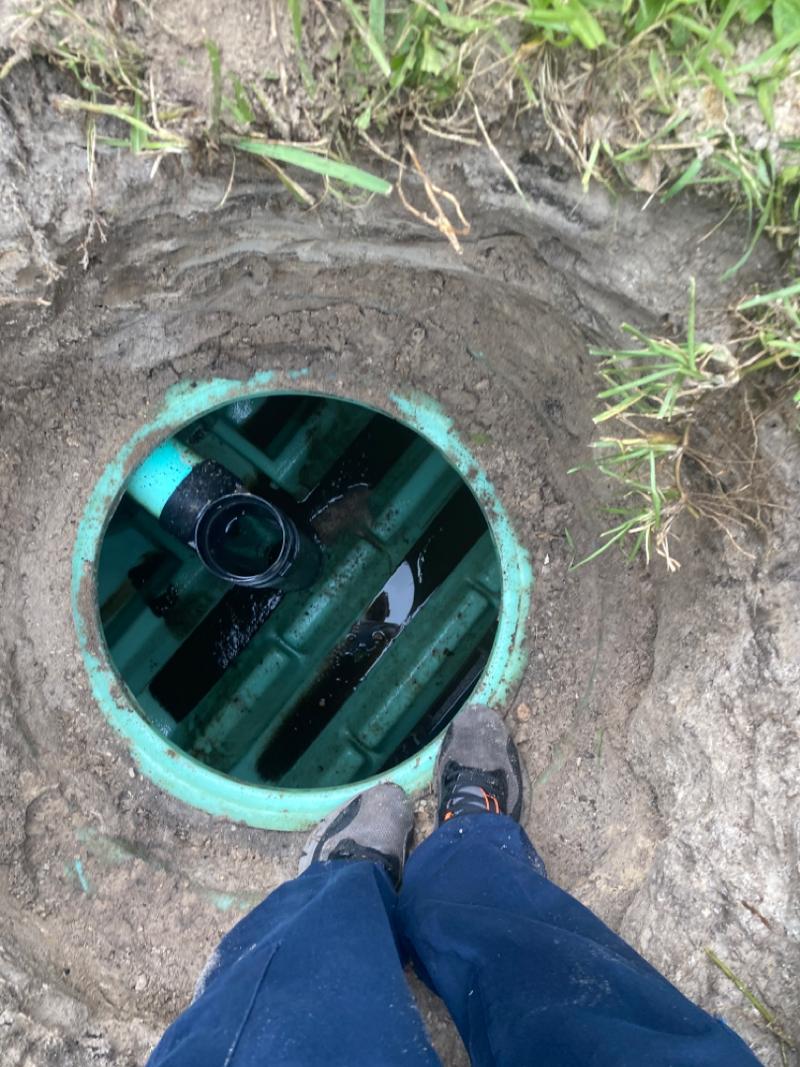 Looking down into a septic system with the cover removed.