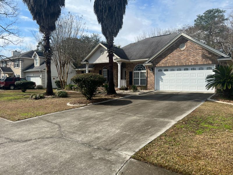 Another view of the same home's driveway needing pressure washed.