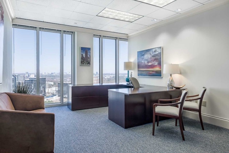 A private office with two large windows.