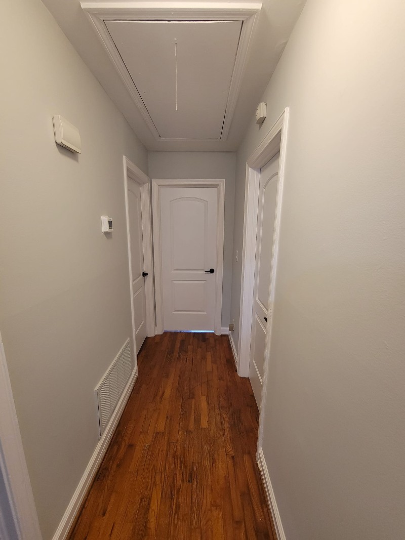 A long hallway with newly installed drywall.