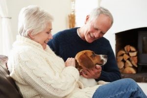 Seniors cuddling with dog