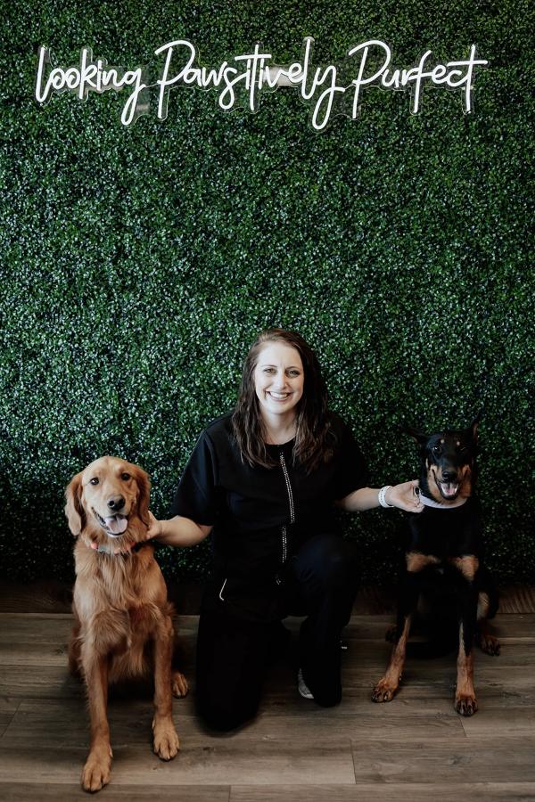 Jenna posing with two dogs