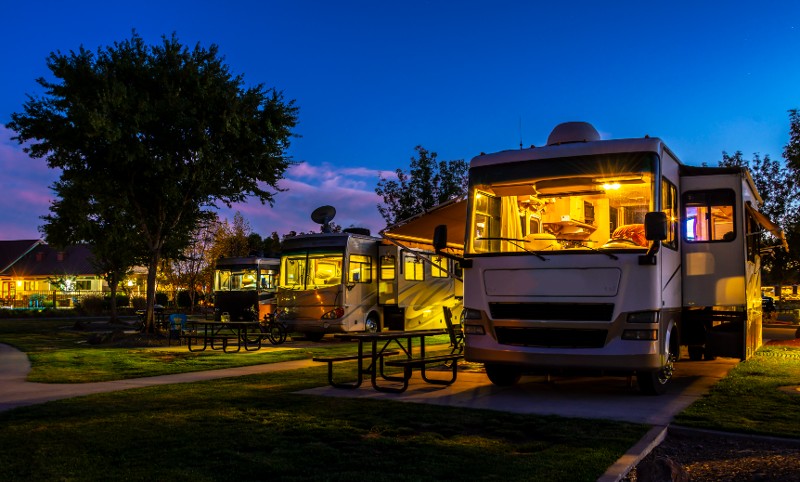 A row of RVs lit up with lights.