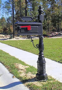 A creative mailbox on a sculpted post and detailed box.