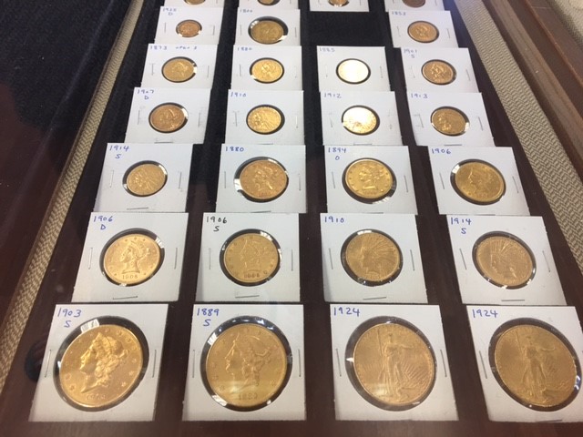 A display of gold coins in individual sleeves.