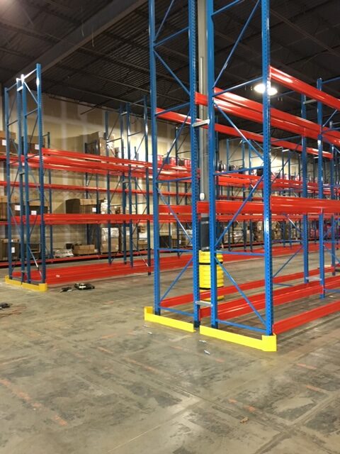 A warehouse filled with pallet racking sections.