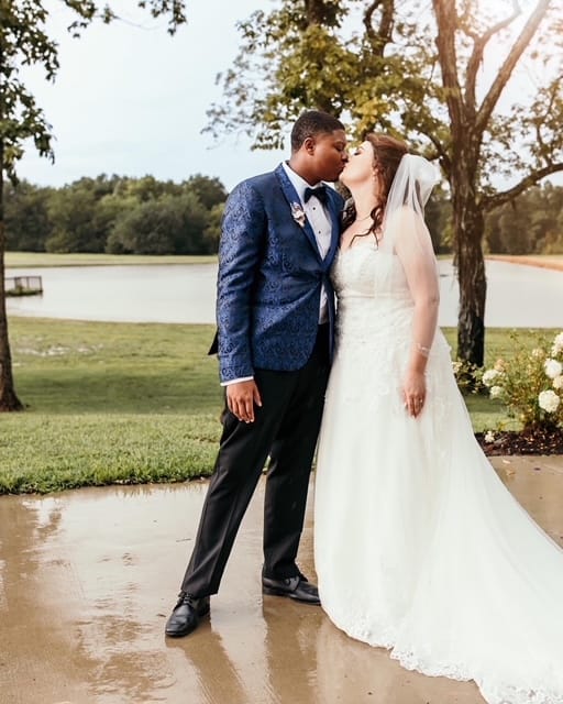 A bride and groom share a kiss.