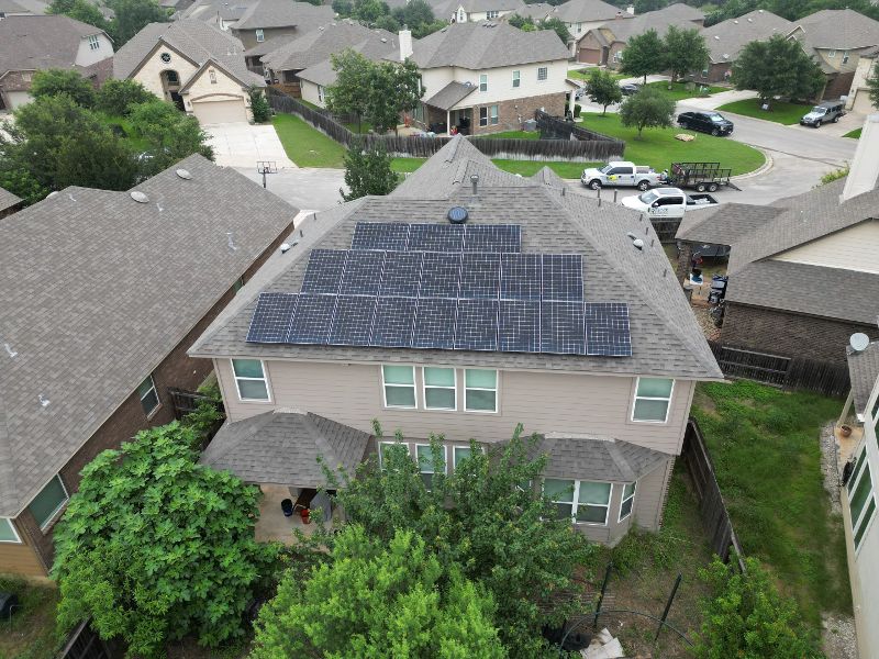 An overhead view of a large home with solar panels on the roof.