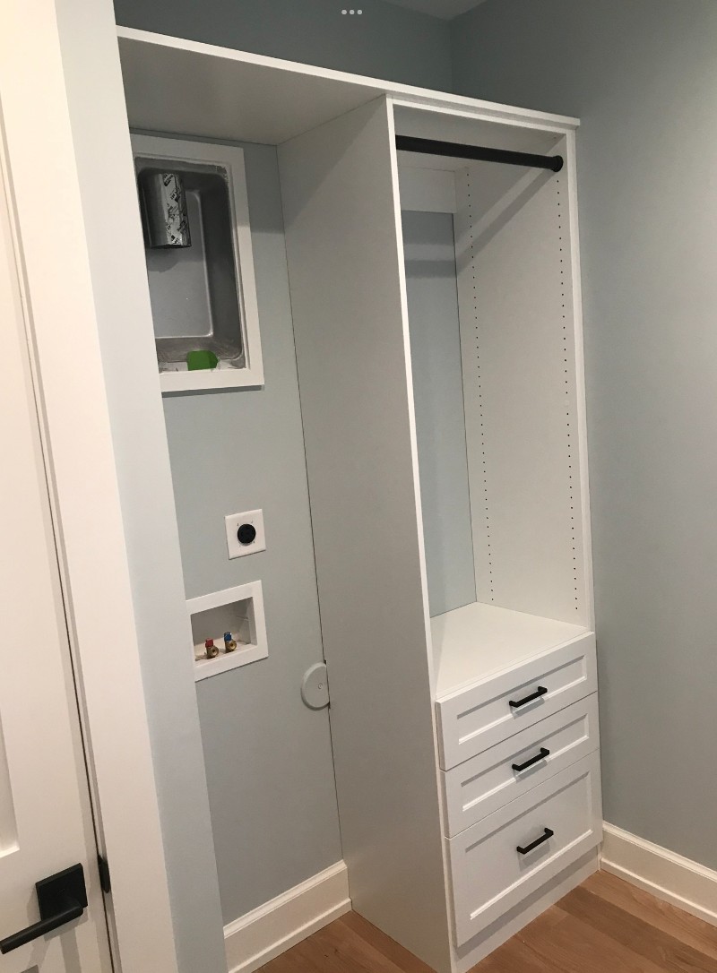A small, closet organizer with three drawers and open space for hanging clothes.