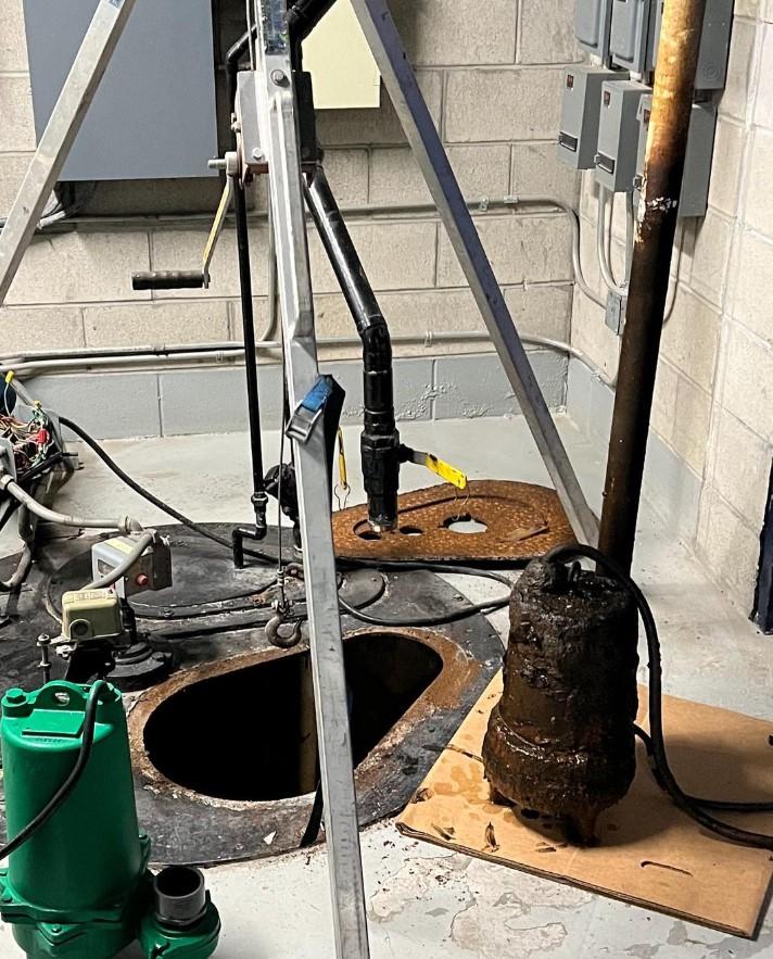 Equipment sits next to a hole over a septic system.