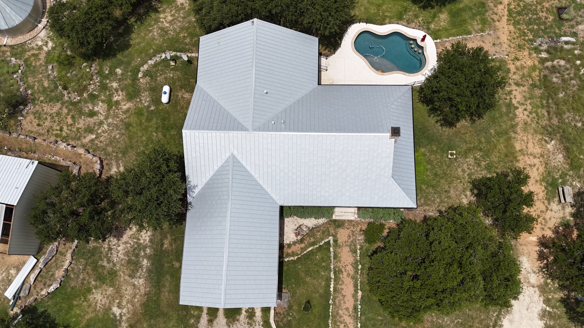 An overhead view of a large home with solar panels on the roof.