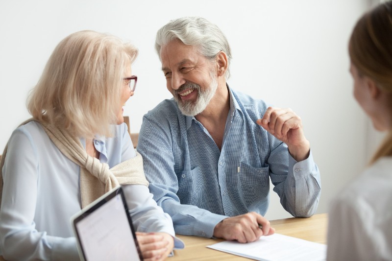 a couple speaking with an insurance agent