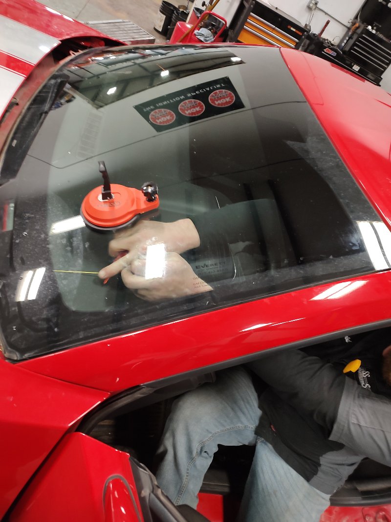 Auto tech replaces a windshield