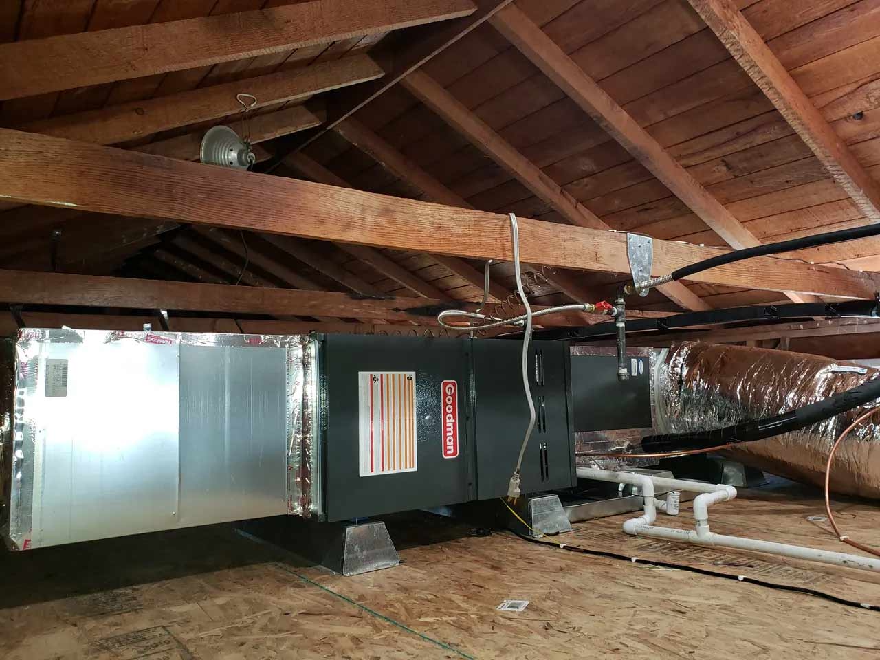 Goodman HVAC unit in an attic.