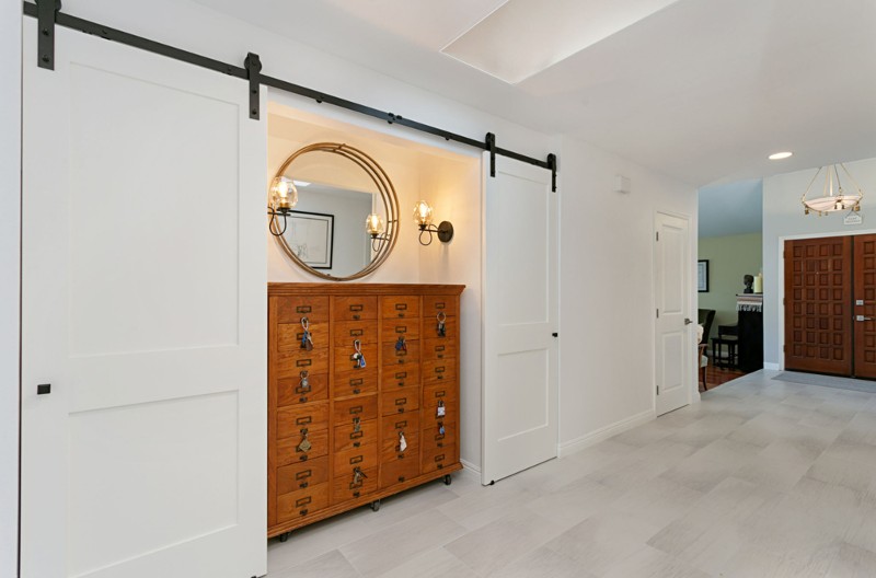 Apothecary cabinet flanked by barn doors in white