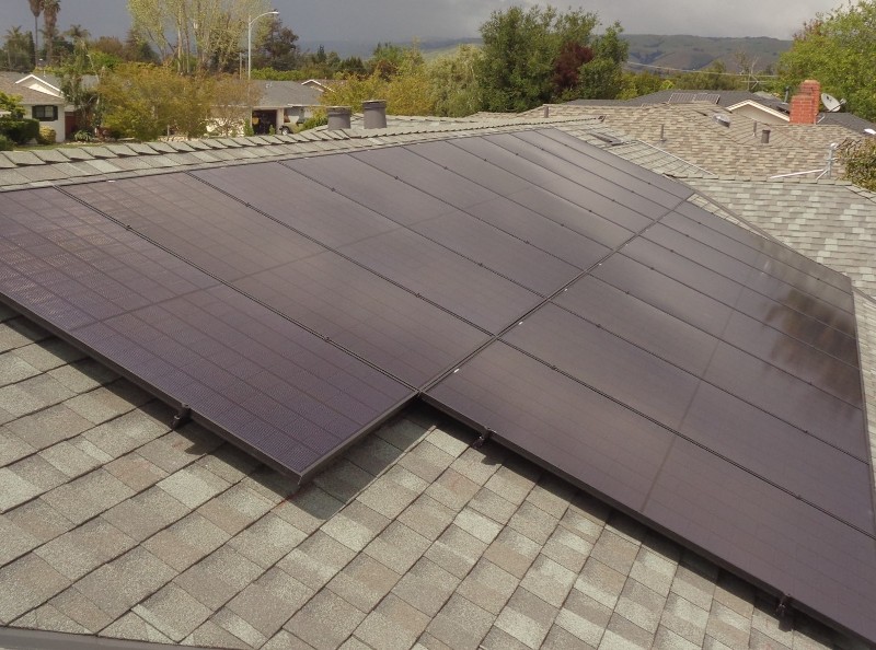 Solar panels on a shingled roof.
