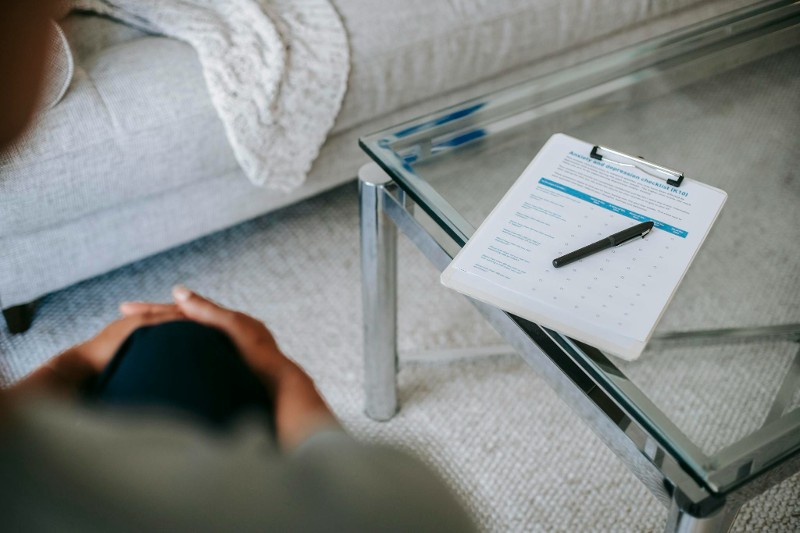 woman looking over document on a clipboard