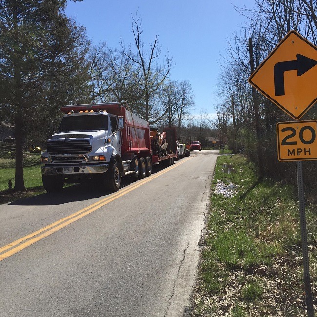 A truck is parked on an asphalt roadway.