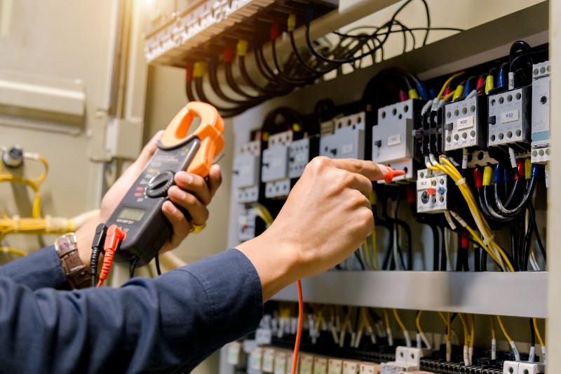 An electrician tests electrical wires.