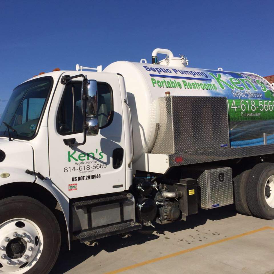 A septic pumping truck from Ken’s Septic Service LLC sits in a parking lot.