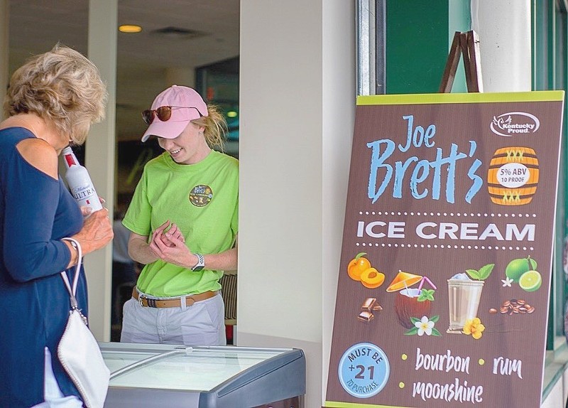 Girl selling three unique flavors of Joe Brett's Ice Cream at an event.