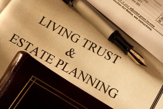 A paper with living trust & estate planning written on it with a pen laying on top of the paper. 