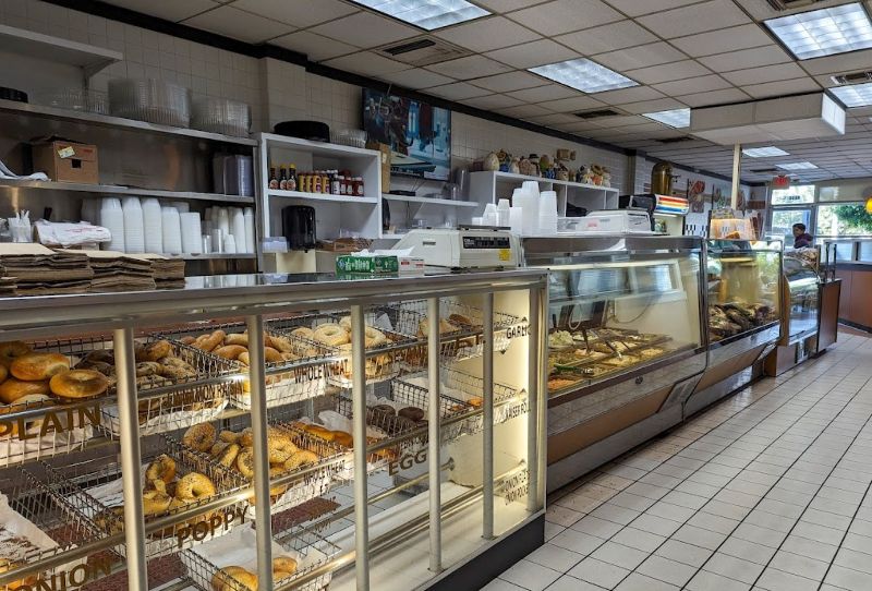 A display counter stocked full of fresh bagels.