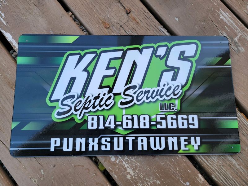 A Ken's Septic Service colorful advertising sign.