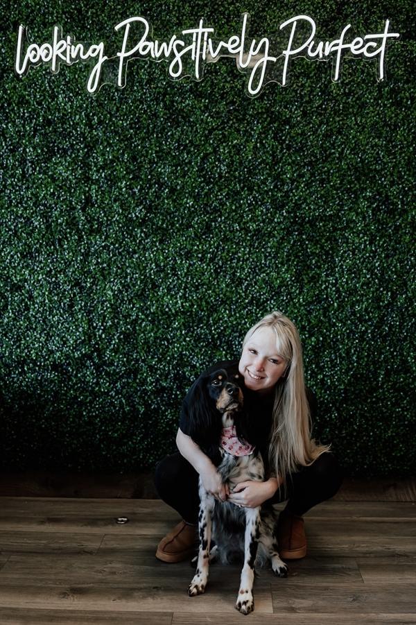 Alicia posing with a dog