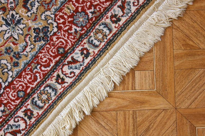 A protected rug on a hardwood floor