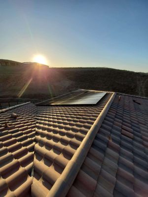 Solar panels on a clay tile roof.