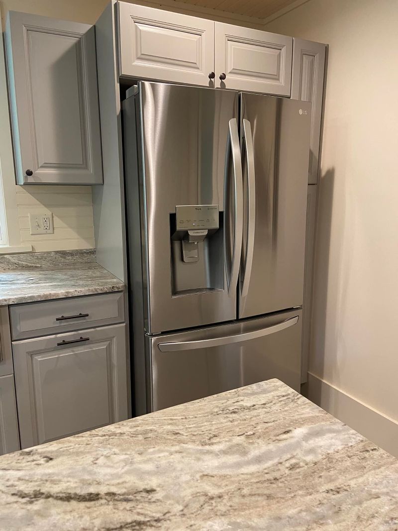 Stainless steel fridge in cabinet section