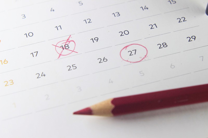 A calendar shows days of the month, one crossed out and one circled in red pencil