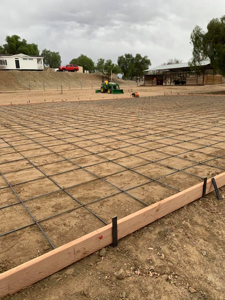 Rebar is laid in a large open area ready for concrete to be poured.