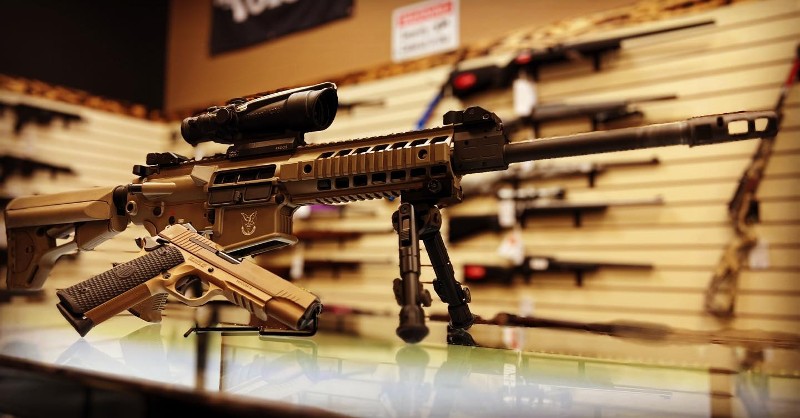 A gold-colored rifle and handgun.