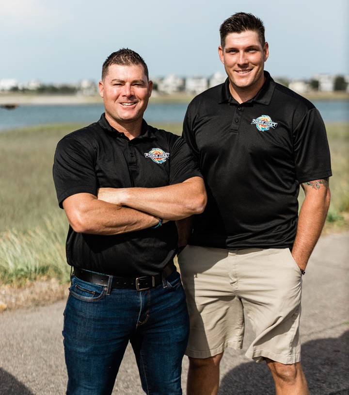 Two Port City Hurricane Shutters employees pose for a photo.