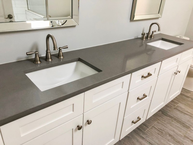 Granite countertops with double bathroom sinks.