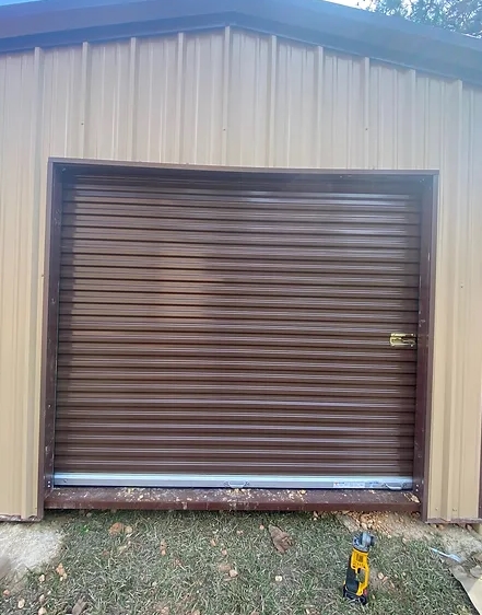Newly installed brown metal roll-up door.