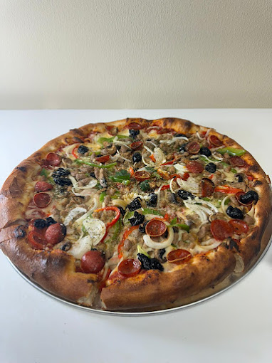 Freshly made supreme pizza, packed with toppings, and finished with a perfectly browned crust